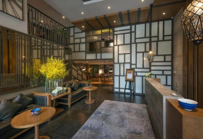 Hanoi La Siesta Trendy Hotel lobby. Gay-friendly hotel with stylish decor, seating area, and reception desk. Ideal for gay men travel in Hanoi.