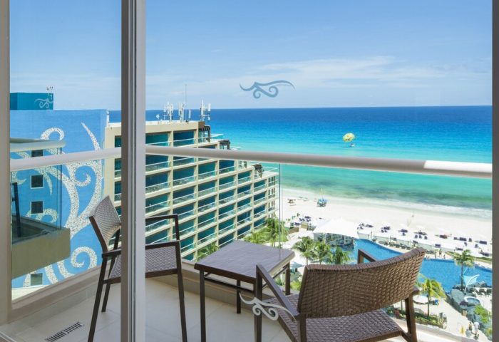 Hard Rock Hotel Cancun all-inclusive balcony view. Gay-friendly hotel room overlooking beach, ocean, and pool. Perfect for gay travel.