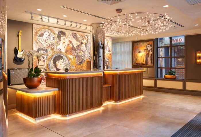 Hard Rock Hotel Dublin's stylish lobby. A gay-friendly hotel with a guitar, portraits, and modern lighting. Dublin travel advice for gay men.