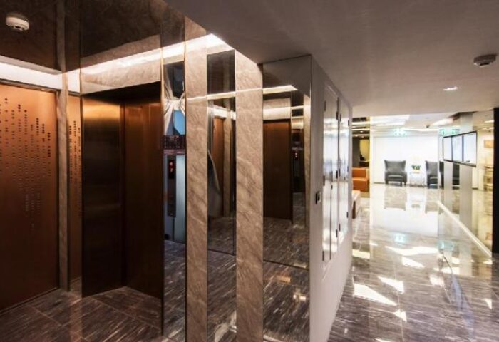 Haven't Met Silom gay-friendly hotel: Hallway with elevators and marble floors. Interior of luxury hotel in Silom, Bangkok, Thailand.
