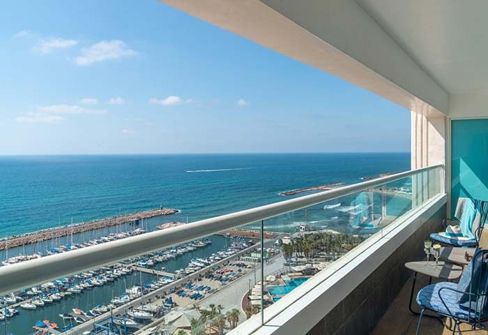 Herods Tel Aviv By The Beach hotel balcony view. Marina, sea, and beach visible. Gay-friendly hotel for gay men's travel in Tel Aviv.