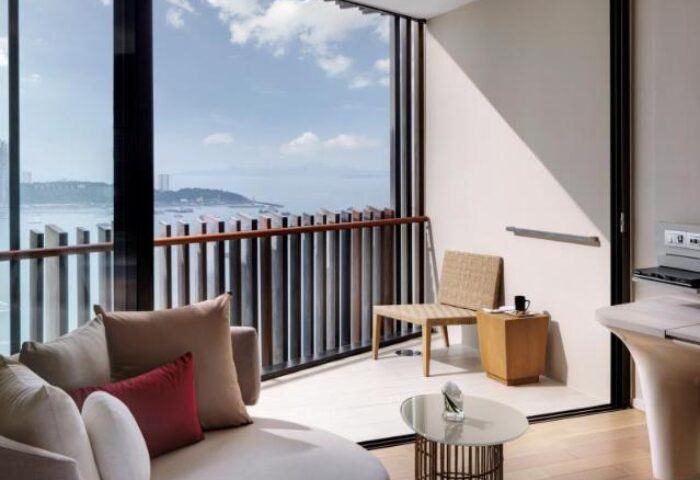 Hilton Pattaya gay-friendly hotel room. Balcony with ocean view, stylish furniture, and modern design. Ideal for gay travelers in Pattaya.