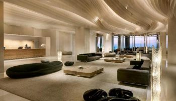 Hilton Pattaya lobby interior. Gay-friendly hotel with modern design, stylish seating, and ocean views. A luxury travel destination for gay men.
