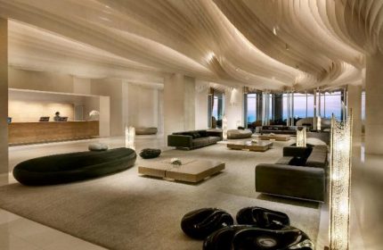 Hilton Pattaya lobby interior. Gay-friendly hotel with modern design, stylish seating, and ocean views. A luxury travel destination for gay men.
