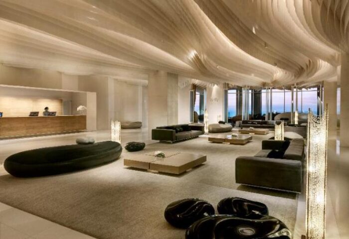 Hilton Pattaya lobby interior. Gay-friendly hotel with modern design, stylish seating, and ocean views. A luxury travel destination for gay men.