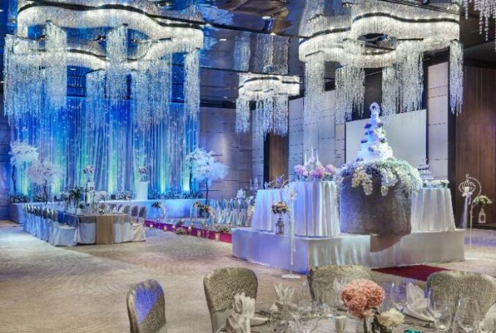 Wedding setup at Gay-Friendly Hotel Hilton Pattaya. Chandelier lighting, tables, chairs, flowers, cake. Gay wedding venue.