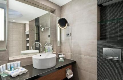 Hilton Tel Aviv gay-friendly hotel bathroom. Modern design with sink, mirror, and toiletries. Ideal for gay men's travel in Tel Aviv.