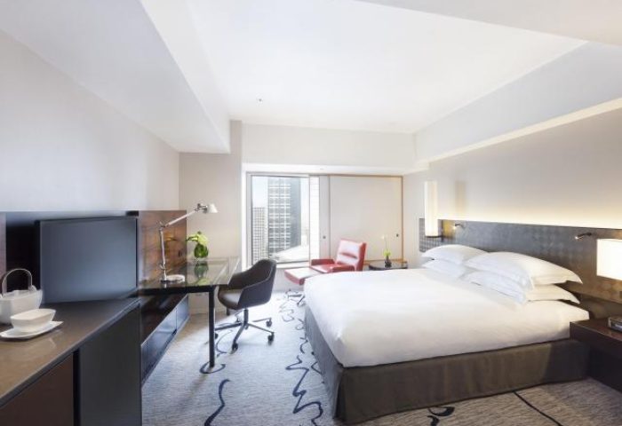 Hilton Tokyo hotel room. Gay-friendly hotel with a king-size bed, desk, and city view. Modern design at this Tokyo hotel.