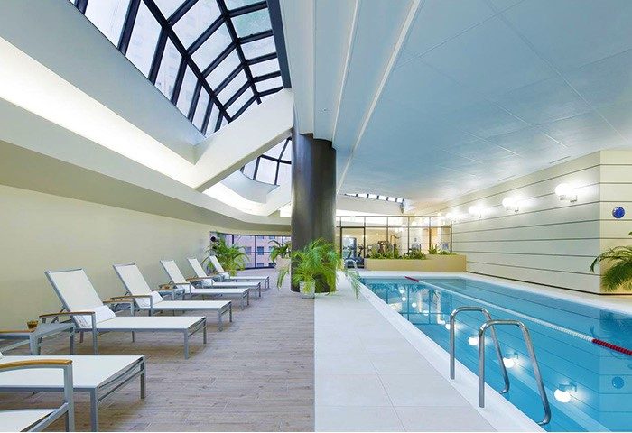 Hilton Tokyo's gay-friendly hotel pool. Relaxing lounge chairs, skylight, and a view of the gym. A great place to unwind in Tokyo.