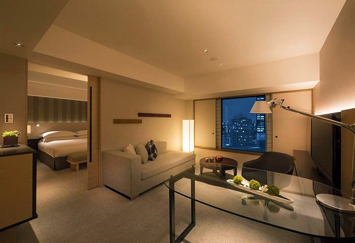 Hilton Tokyo gay-friendly hotel room. Modern design with a bed, couch, desk, and city view. Great for gay men's travel to Tokyo, Japan.