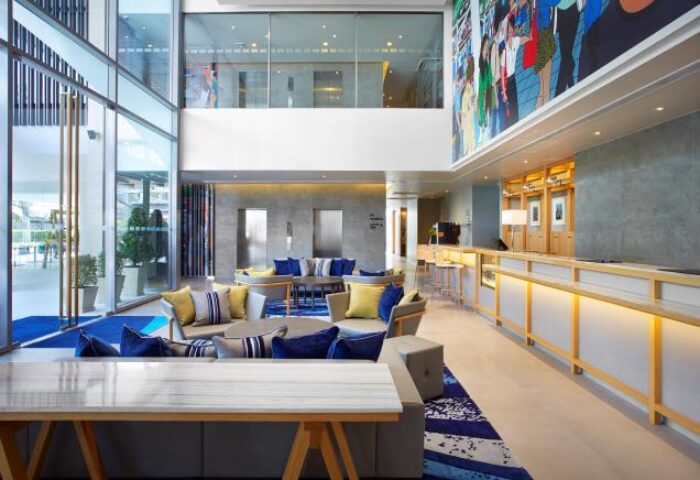 Holiday Inn Express Bangkok Sathorn lobby. Gay-friendly hotel with modern decor, colorful art, and comfortable seating. Sathorn, Bangkok.