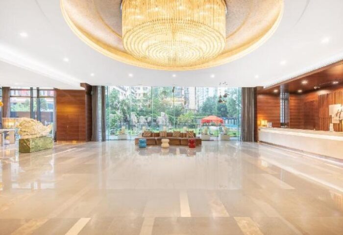 Holiday Inn Express Beijing Dongzhimen lobby. Gay-friendly hotel with modern design, large windows, and stylish chandelier. Comfortable & welcoming.