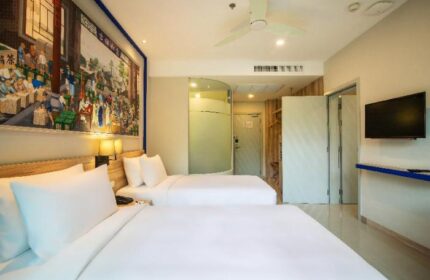 Holiday Inn Express Krabi Ao Nang Beach gay-friendly hotel room. Two beds, TV, bathroom, and mural on the wall. Great for gay travel.