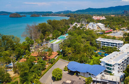 Holiday Inn Express Krabi Ao Nang Beach aerial view. Gay-friendly hotel near the beach, featuring a pool, lush greenery, and ocean views.