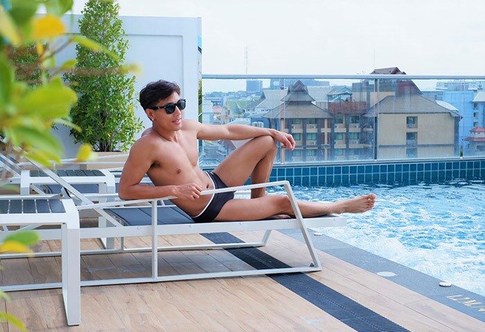Gay-friendly Holiday Inn Express Pattaya Central: Man relaxing poolside. A perfect hotel for gay travelers in Pattaya, Thailand.