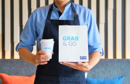 Holiday Inn Express Pattaya Central: Staff holding a Grab & Go bag and coffee. Gay-friendly hotel in Pattaya, Thailand.