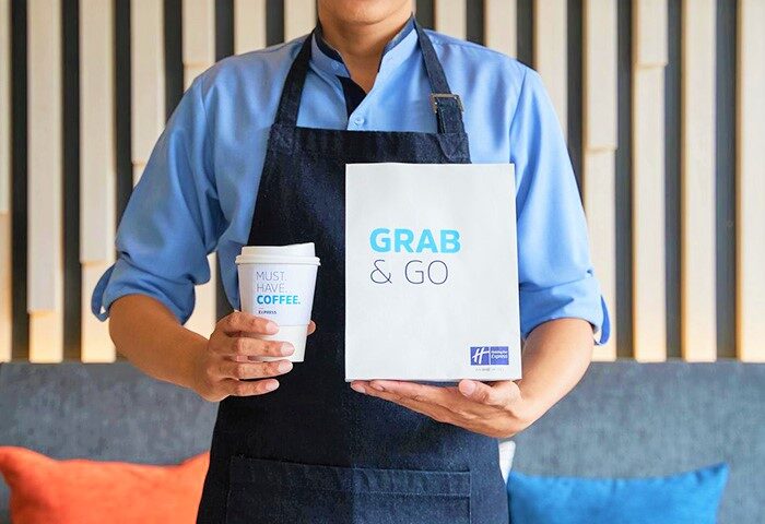 Holiday Inn Express Pattaya Central: Staff holding a Grab & Go bag and coffee. Gay-friendly hotel in Pattaya, Thailand.