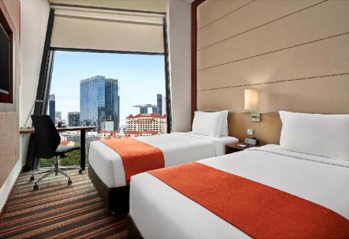 Holiday Inn Express Singapore Clarke Quay twin room view. Gay-friendly hotel, SG Clean Certified. Modern design, city view, desk.