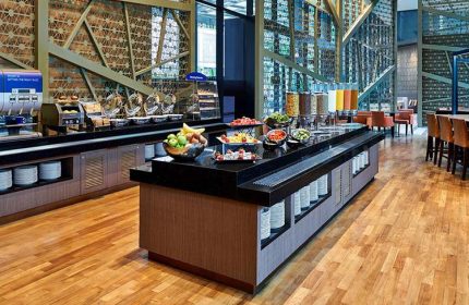 Breakfast buffet at Holiday Inn Express Singapore Clarke Quay, a gay-friendly hotel. Food includes fruit, cereal, and pastries. SG Clean Certified.