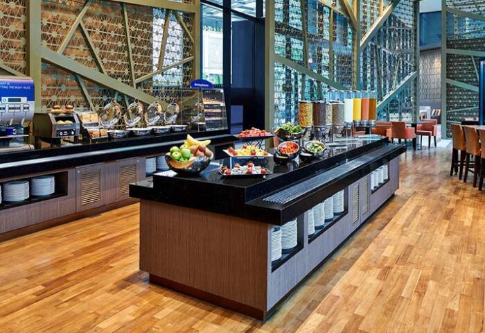 Breakfast buffet at Holiday Inn Express Singapore Clarke Quay, a gay-friendly hotel. Food includes fruit, cereal, and pastries. SG Clean Certified.