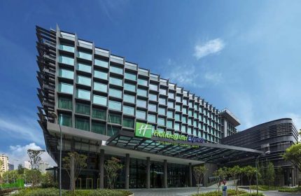 Holiday Inn Express Singapore Clarke Quay, a gay-friendly hotel. Modern building exterior with a blue sky. SG Clean Certified hotel.