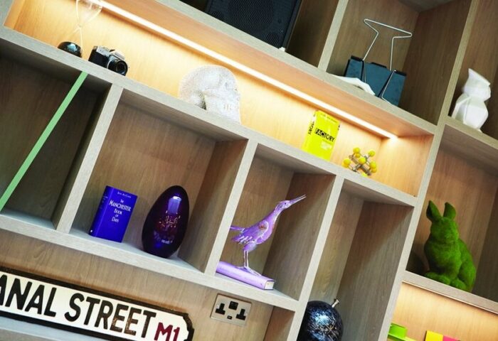 Holiday Inn Manchester City Centre: Gay-friendly hotel room decor. Canal Street sign, skull, rabbit, and other quirky ornaments on shelves.