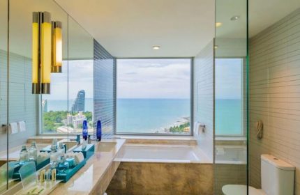 Holiday Inn Pattaya bathroom with ocean view. Gay-friendly hotel featuring modern fixtures, bathtub, and luxurious amenities.