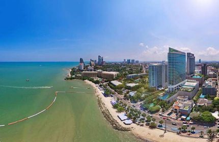 Holiday Inn Pattaya, a gay-friendly hotel. Aerial view of the beach, city skyline, and the hotel. Great location for gay travelers.