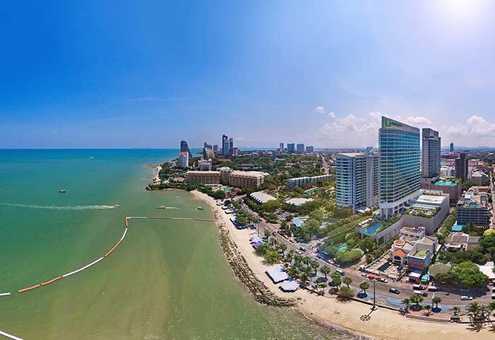 Holiday Inn Pattaya, a gay-friendly hotel. Aerial view of the beach, city skyline, and the hotel. Great location for gay travelers.