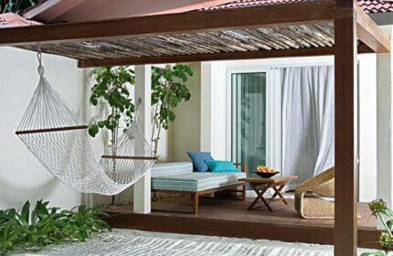 Holiday Inn Resort Kandooma Maldives gay-friendly hotel room. Hammock, daybed, and table on a private deck. Ideal for gay travel.