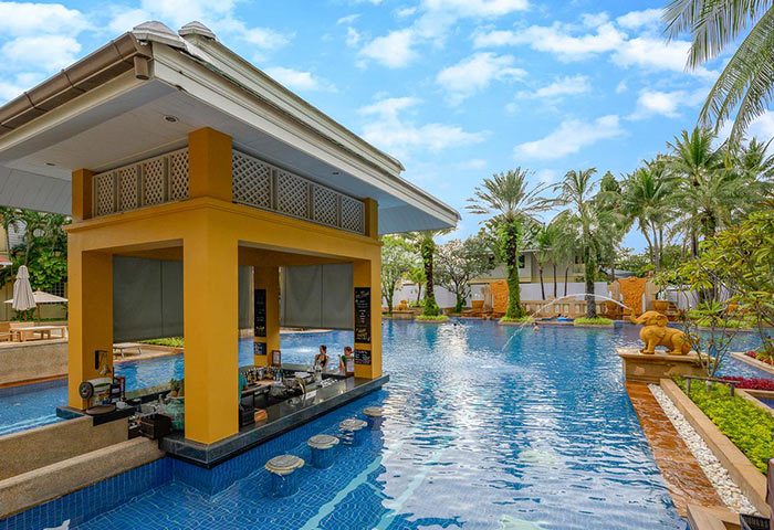 Holiday Inn Resort Phuket gay-friendly hotel pool bar. Swim-up bar with stools in the pool. Tropical resort for gay travelers.