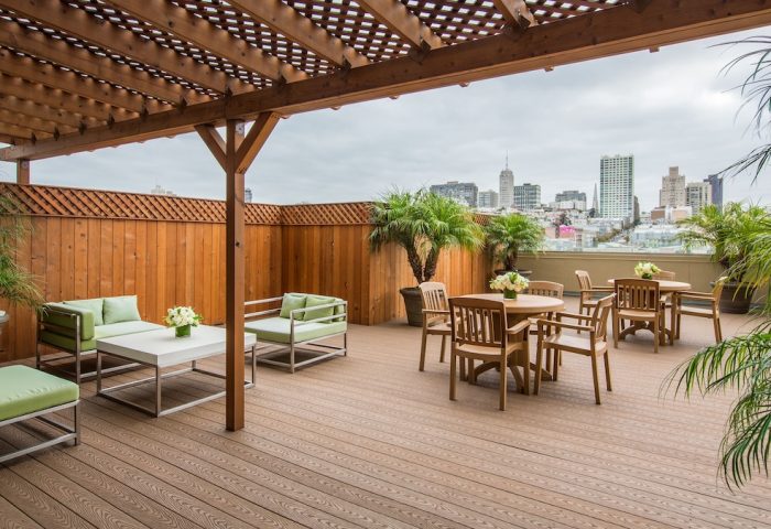Holiday Inn San Francisco Golden Gateway gay-friendly hotel patio. Outdoor seating area with city views, plants, and wooden pergola.