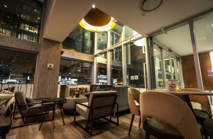 Holiday Inn Toronto Downtown Centre's stylish lobby. A gay-friendly hotel with modern seating, large windows, and warm lighting. Perfect for travelers.