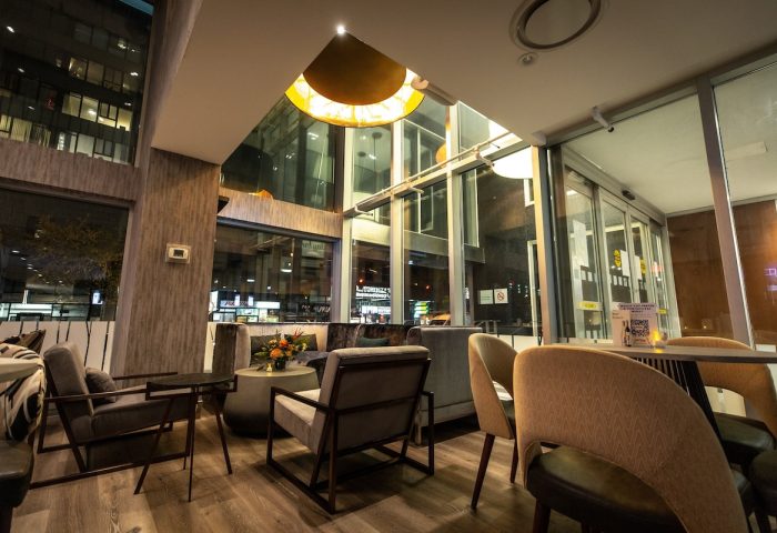 Holiday Inn Toronto Downtown Centre's stylish lobby. A gay-friendly hotel with modern seating, large windows, and warm lighting. Perfect for travelers.