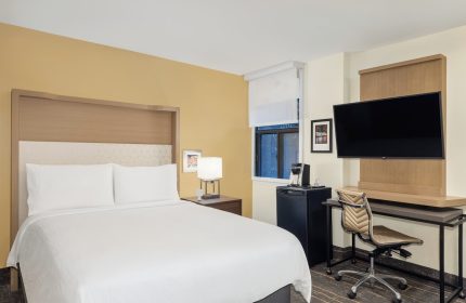 Holiday Inn Toronto Downtown Centre guest room. Gay-friendly hotel with a bed, desk, TV, mini fridge, and coffee maker.