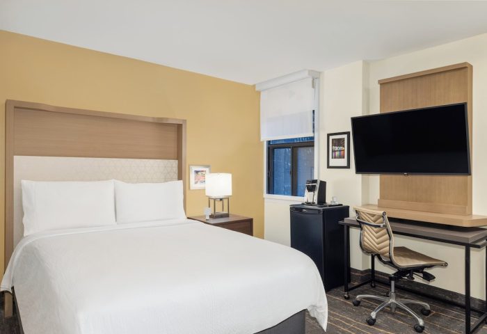 Holiday Inn Toronto Downtown Centre guest room. Gay-friendly hotel with a bed, desk, TV, mini fridge, and coffee maker.