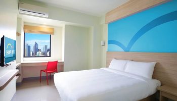 Hop Inn Hotel Makati Avenue Manila room. Gay-friendly hotel with city view. Clean, modern design. Perfect for gay travel in Manila.