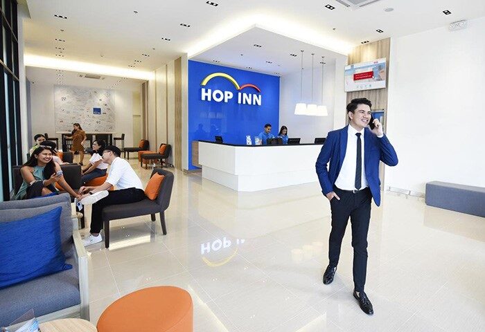 Hop Inn Hotel Tomas Morato Quezon City lobby view. Gay-friendly hotel with modern design, reception, and guests. Perfect for gay travel.