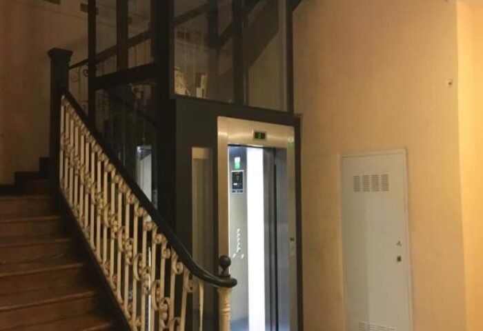 Staircase and elevator at Gay-Friendly Hotel Hostal Pizarro, a gay men travel destination. Accessibility and historic charm blend seamlessly.