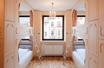 Hostel die Wohngemeinschaft room. Gay-friendly hotel with bunk beds, ladders, and a window. A unique lodging choice for gay travelers.