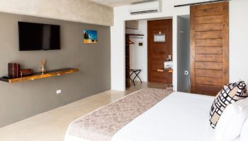 Hotel 52 gay-friendly hotel room. Modern design with TV, wood accents, and a comfortable bed. Perfect for gay travel and relaxation.