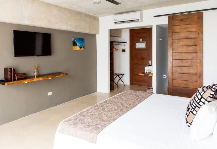 Hotel 52 gay-friendly hotel room. Modern design with TV, wood accents, and a comfortable bed. Perfect for gay travel and relaxation.