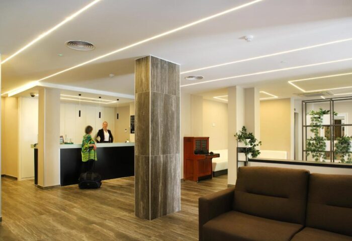 Hotel Alameda lobby. Gay-friendly hotel reception area with sleek design, modern lighting, and comfortable seating. Welcoming space for gay travelers.