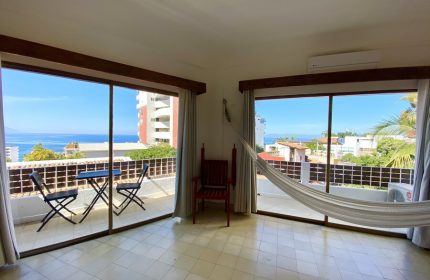 Hotel Amaca Puerto Vallarta Adults Only room. Gay-friendly hotel balcony view, hammock, table, and chairs. Perfect for a relaxing vacation.