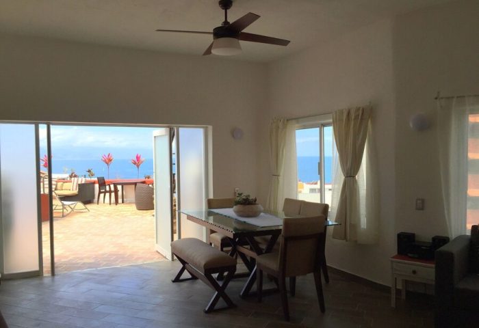 Hotel Amaca Puerto Vallarta Adults Only suite. Dining area with ocean view. Gay-friendly hotel with outdoor lounge.