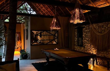 Hotel Bardo Adults Only gay-friendly hotel interior. Billiard room with thatched roof, stone wall, hammock. Relaxing space for gay travelers.