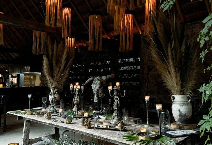 Hotel Bardo Adults Only dining area. Gay-friendly hotel with unique decor, featuring rustic table setting, candles, and hanging light fixtures.