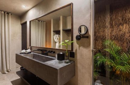Hotel Bardo Adults Only bathroom. Modern design, concrete sink, large mirror, and tropical plants. Gay-friendly hotel for a relaxing getaway.