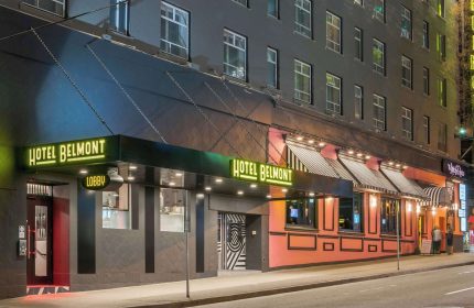 Hotel Belmont Vancouver Mgallery's exterior at night. Gay-friendly hotel with neon signs. Great location for gay travelers.