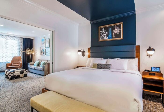 Hotel Belmont Vancouver Mgallery suite: bedroom with king bed, seating area. Gay-friendly hotel room with modern design. Vancouver travel.